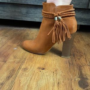 Tan braided accented booties.